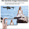 Drone capturing HD real-time video of woman meditating by the sea, viewed on smartphone, Tafeen Toys